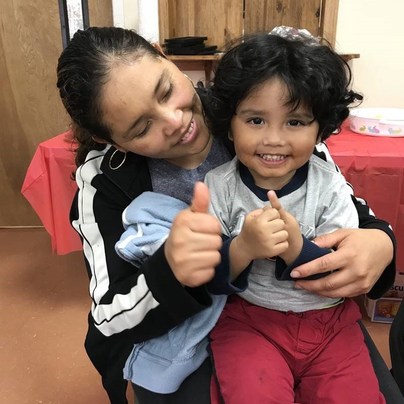 Caterpillar Ministries, mom and child thumbs up Caterpillar Ministries, mom and child giving a thumbs up